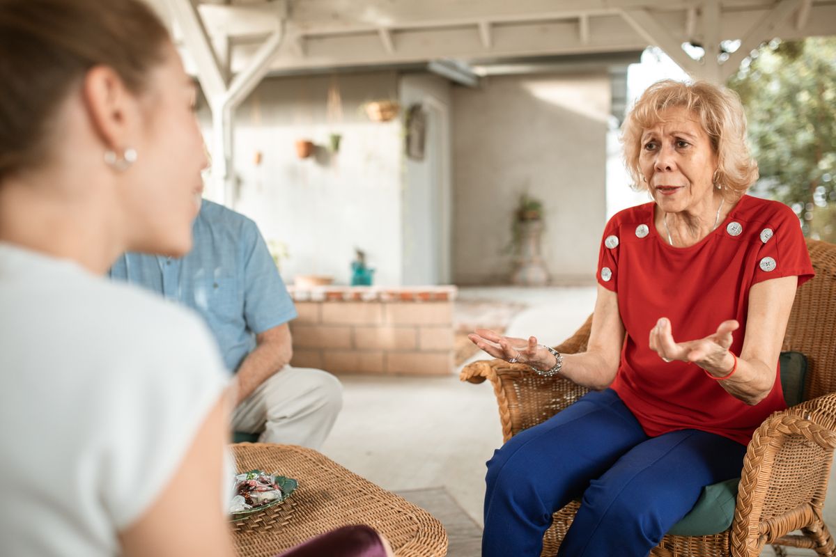 Older woman sharing her experience in a conversation at home